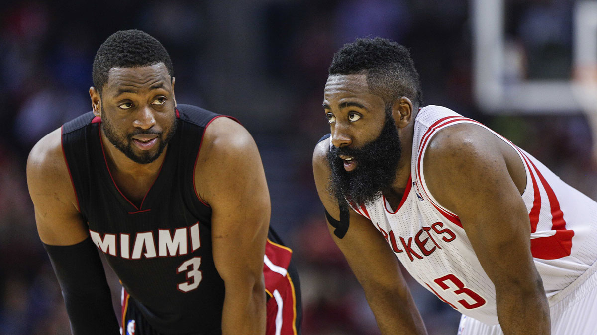 Miami Heat guard Dwyane Wade (3) and Houston Rockets guard James Harden (13) talk during the second quarter at Toyota Center.