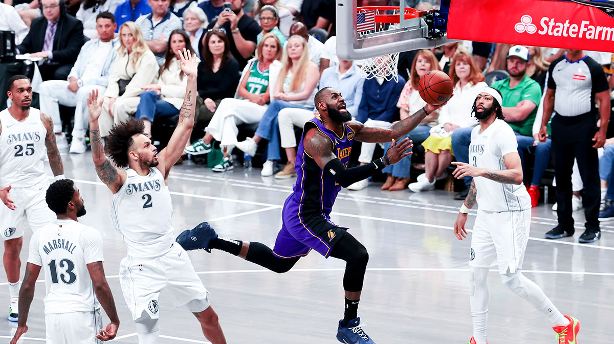 Los Angeles Lakers forward LeBron James (23) shoots past Dallas Mavericks center Dereck Lively II (2) and Dallas Mavericks forward Anthony Davis (3) during the second half at American Airlines Center.