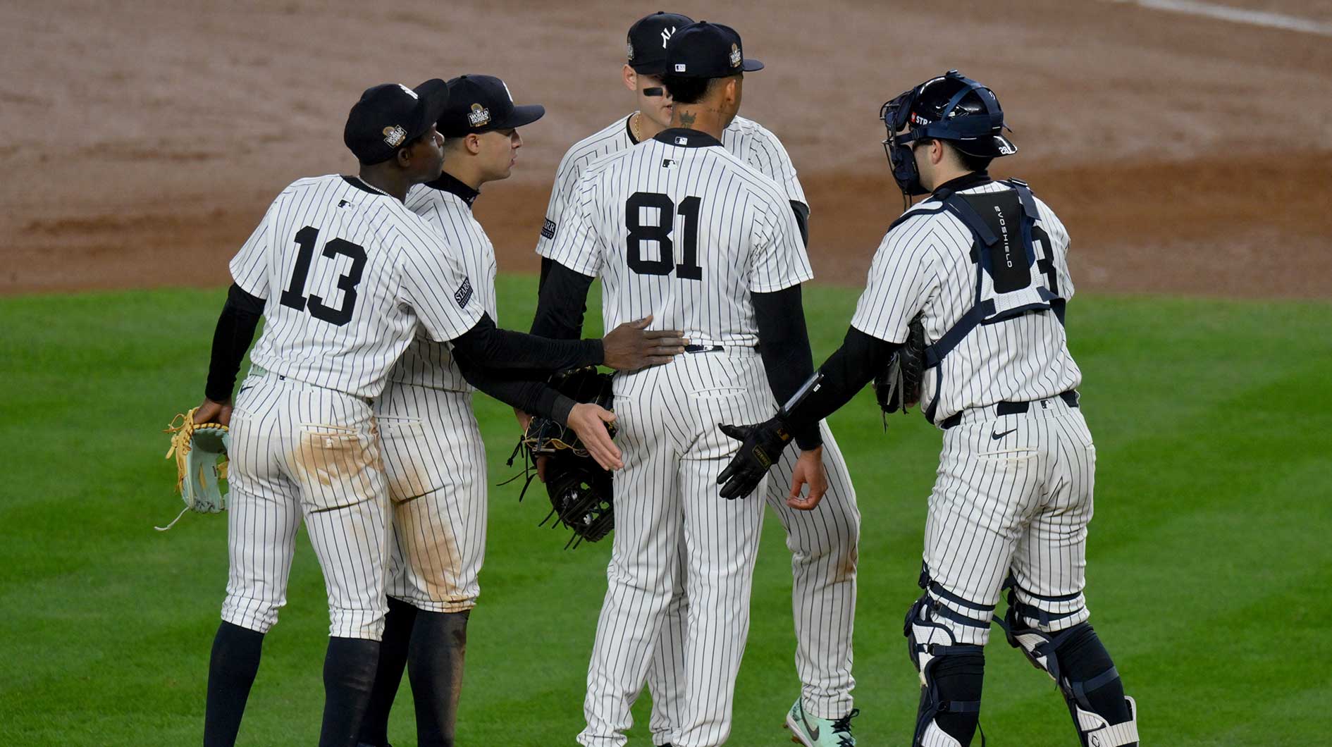 New York Yankees pitcher Luis Gil (81) is congratulated by teammates as he exits the game during the fifth inning against the Los Angeles Dodgers in game four of the 2024 MLB World Series at Yankee Stadium.