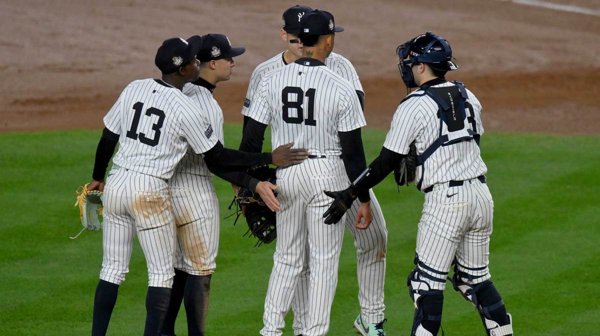 New York Yankees pitcher Luis Gil (81) is congratulated by teammates as he exits the game during the fifth inning against the Los Angeles Dodgers in game four of the 2024 MLB World Series at Yankee Stadium.