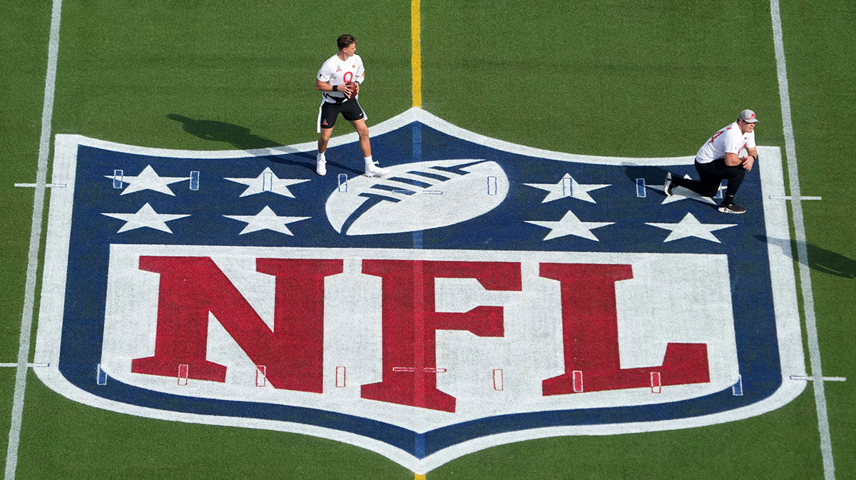 Feb 2, 2025; Orlando, FL, USA; AFC quarterback Joe Burrow of the Cincinnati Bengals (9) throws the ball on the NFL shield logo during the 2025 Pro Bowl Games at Camping World Stadium.