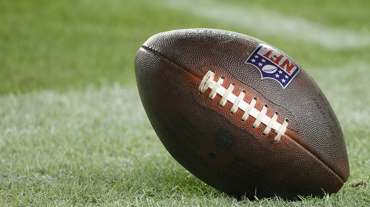 An official game ball rolls on the field during the second half of the game against the Atlanta Falcons and the Washington Commanders at Northwest Stadium.