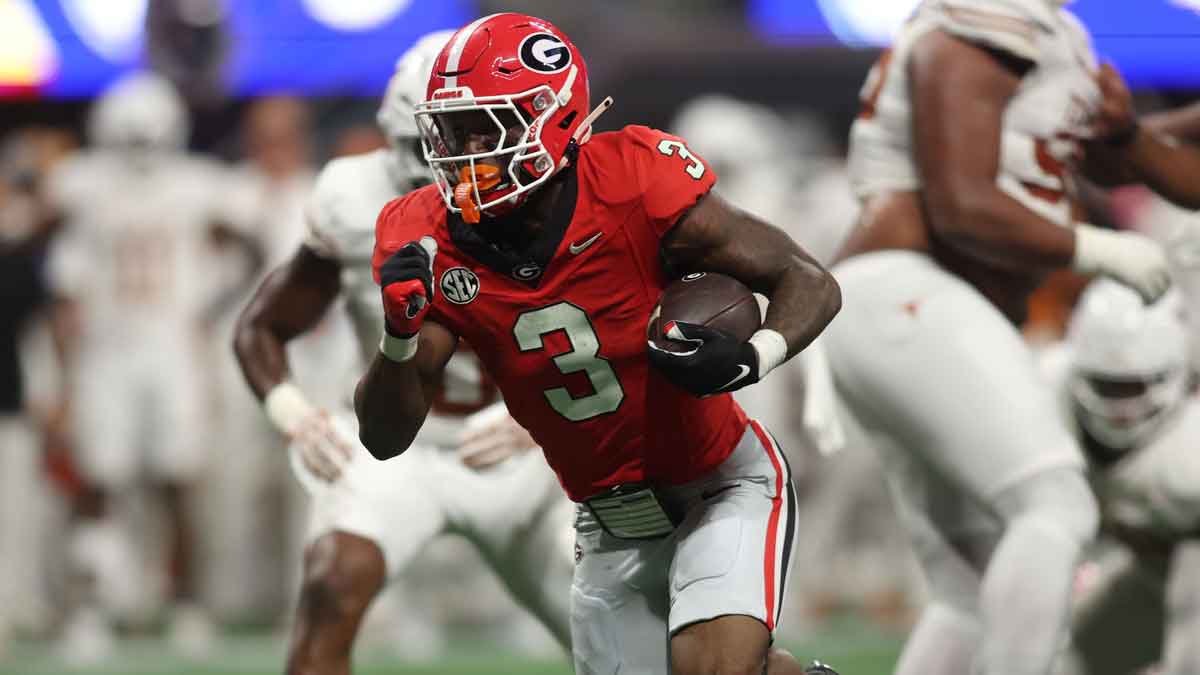 Georgia Bulldogs running back Nate Frazier (3) rushes the ball against the Texas Longhorns during the second half in the 2024 SEC Championship game at Mercedes-Benz Stadium.