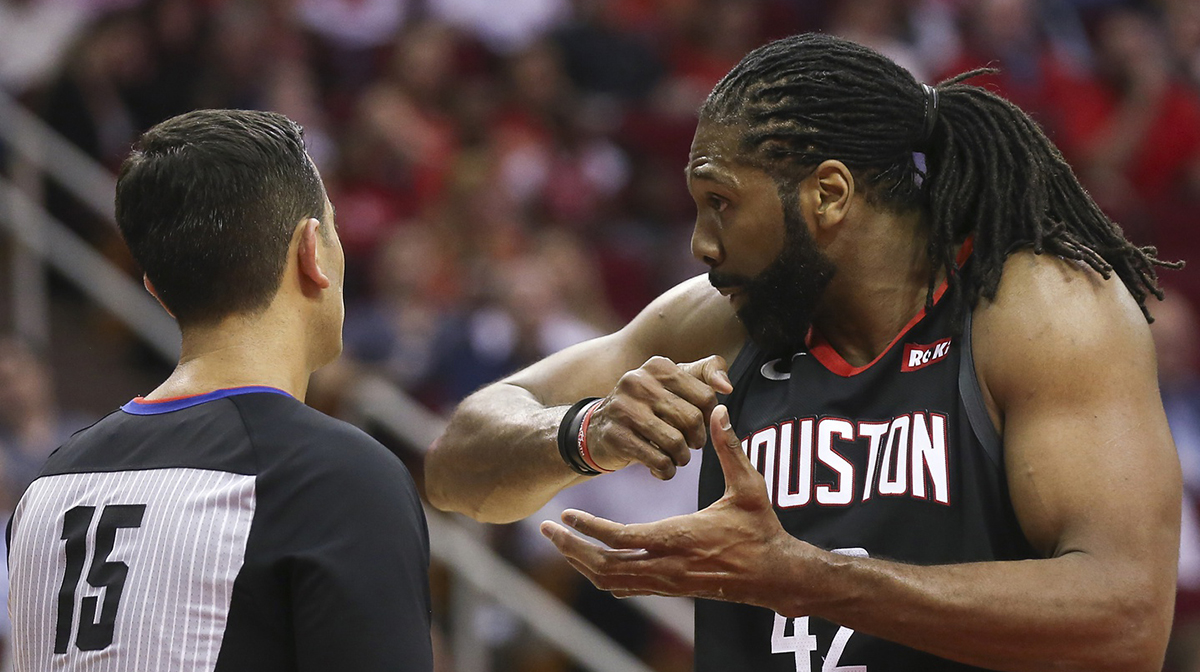 Houston Rockets center Nene Hilario (42) explains a play to official Zach Zarba (15) in game against the San Antonio Spurs in the second half at Toyota Center.