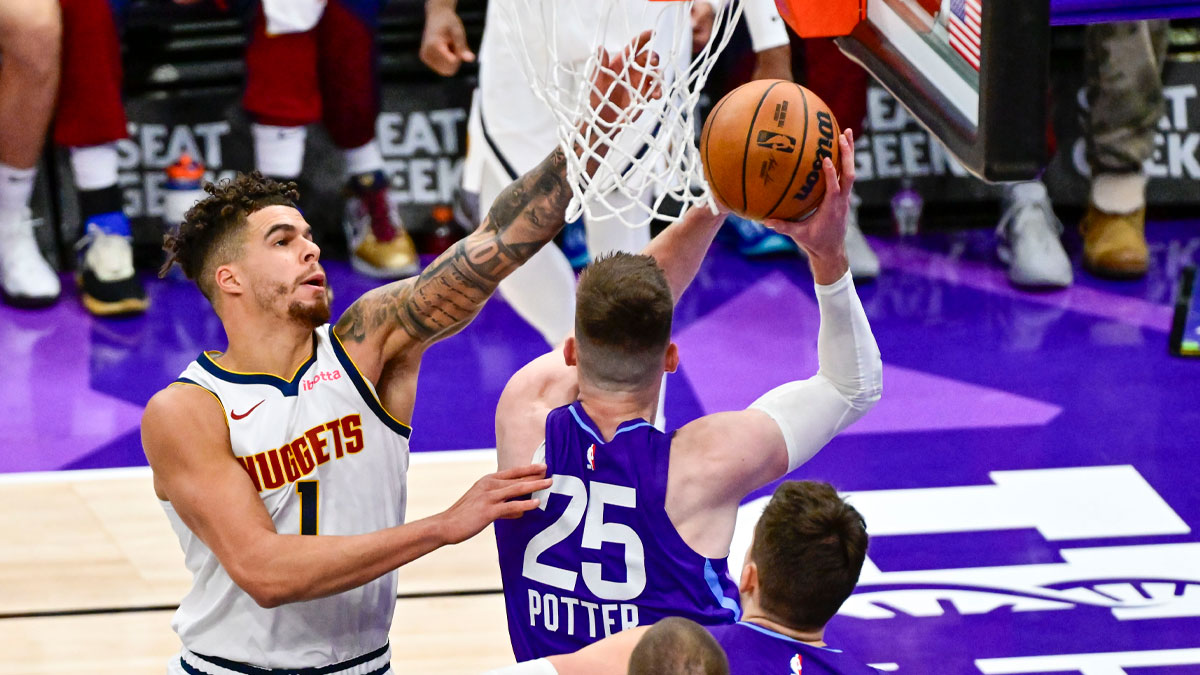 Utah Jazz center Micah Potter (25) attempts a shot against Denver Nuggets forward Michael Porter Jr. (1 Now a Nets player) during the second half at the Delta Center.