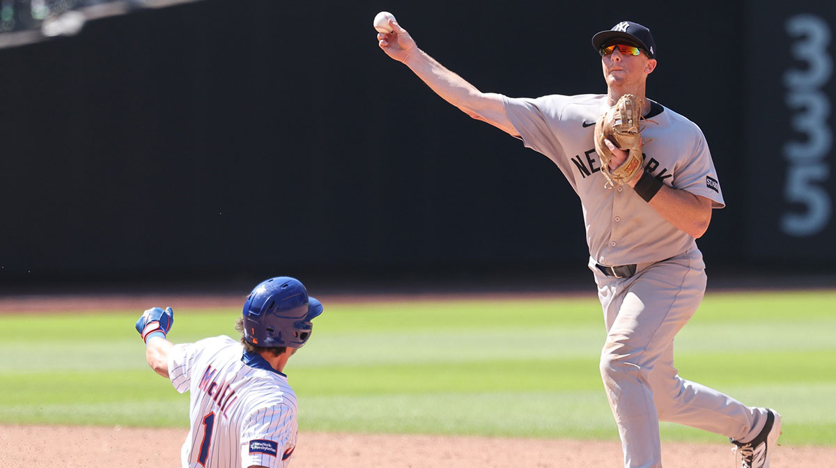 New York Yankees second baseman DJ LeMahieu (26) forces out New York Mets second baseman Jeff McNeil (1) at second base and throws to first to complete the double play on a ball hit by catcher Hayden Senger (not pictured) during the sixth inning at Citi Field. Mets pinch hitter Ronny Mauricio (np) scored on the play.