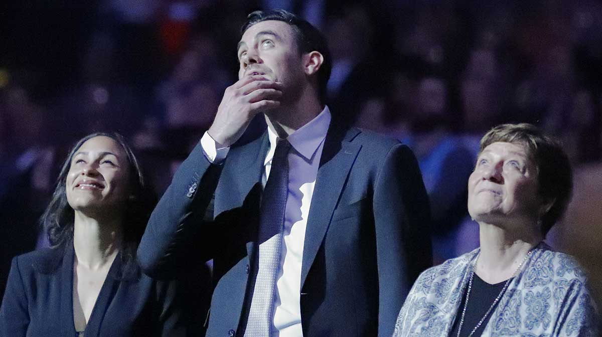 Former Oklahoma City forward Nick Collison (center) along with his wife (left) and mother (right) watch a video regarding his jersey retirement prior to the start of a game against the Toronto Raptors at Chesapeake Energy Arena.