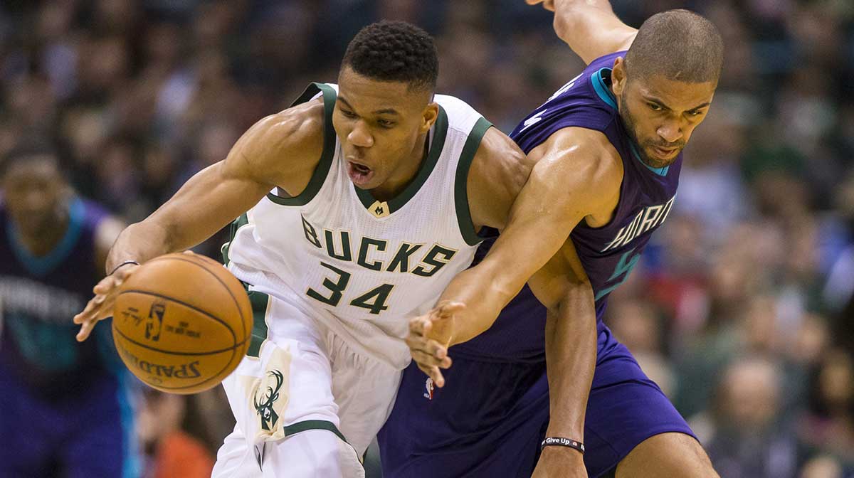 Milwaukee Bucks forward Giannis Antetokounmpo (34) and Charlotte Hornets guard Nicolas Batum (5) reach for the loose ball during the second quarter at BMO Harris Bradley Center.