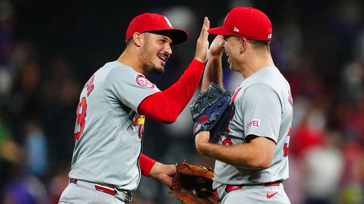 St. Louis Cardinals third base Nolan Arenado (28) and relief pitcher Ryan Helsley (56) celebrate defeating the Colorado Rockies at Coors Field.