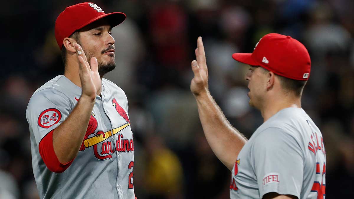 St. Louis Cardinals third baseman Nolan Arenado (28) and relief pitcher Ryan Helsley (56) celebrate after defeating the Pittsburgh Pirates at PNC Park. St. Louis won 2-1.