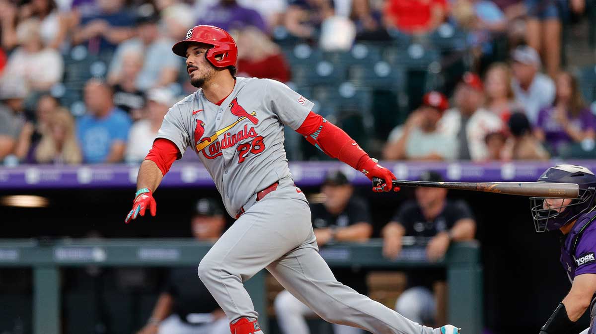 St. Louis Cardinals third baseman Nolan Arenado (28) hits a single in the sixth inning against the Colorado Rockies at Coors Field.
