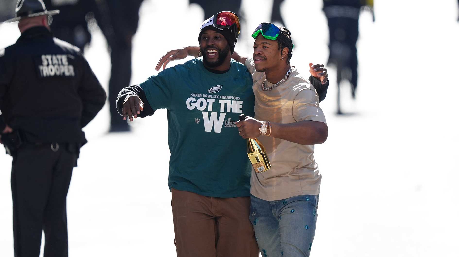 Jalyx Hunt (left) and Nolan Smith Jr (right) walk the parade route during the Super Bowl LIX championship parade and rally.