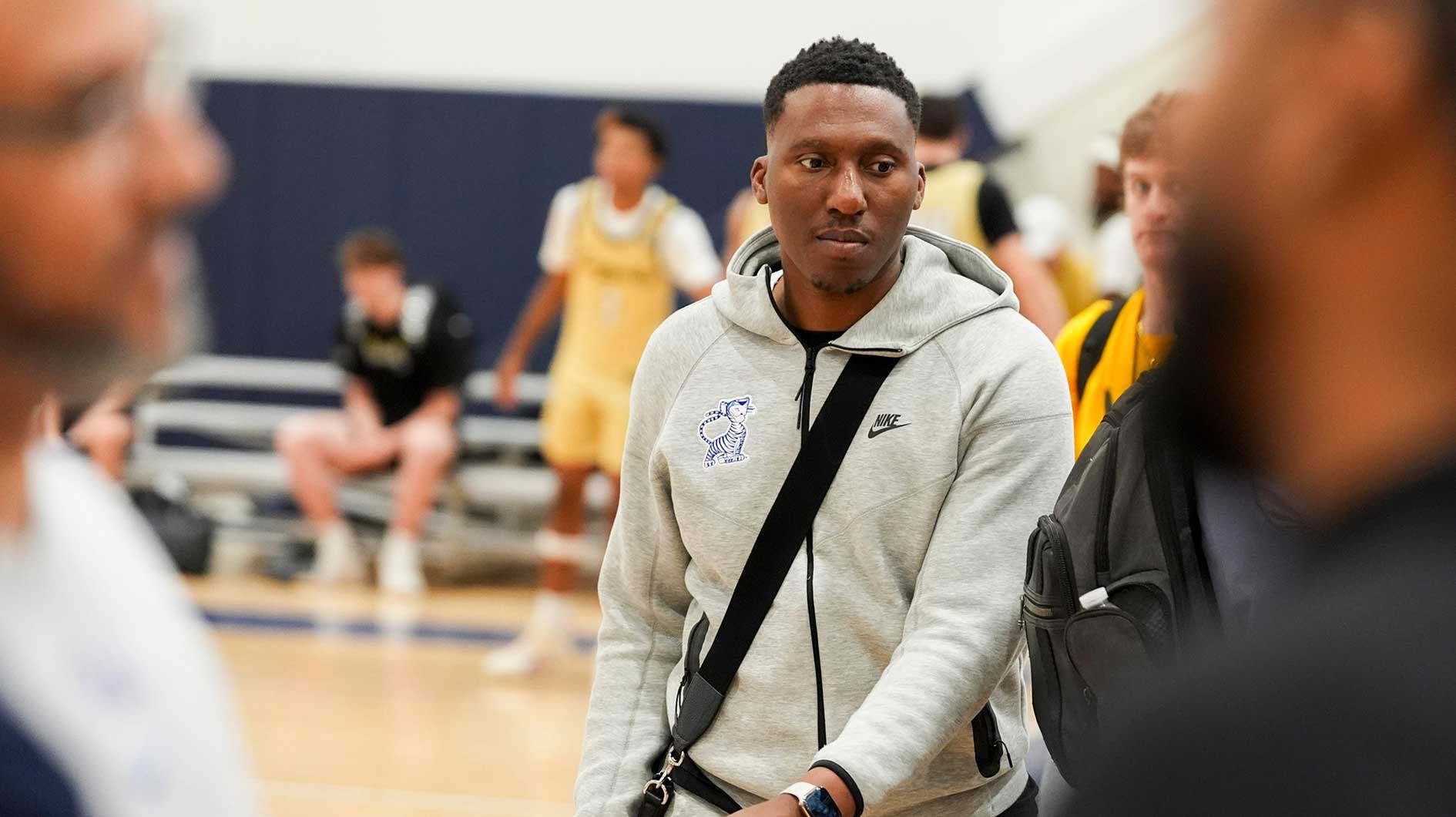 University of Memphis assistant coach Nolan Smith walks from one court to another