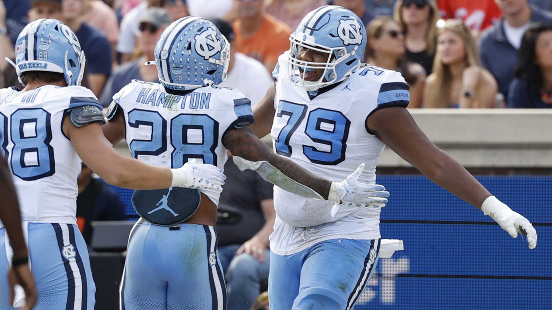 North Carolina Tar Heels running back Omarion Hampton (28) celebrates with Tar Heels offensive lineman Howard Sampson (79) after scoring a touchdown against the Virginia Cavaliers during the first half at Scott Stadium. Mandatory Credit: Geoff Burke-Imagn Images