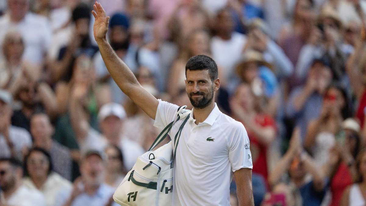 Novak Djokovic of Serbia leaves the court after losing his match to Jannik Sinner of Italy after their match on day 12 at All England Lawn Tennis and Croquet Club.