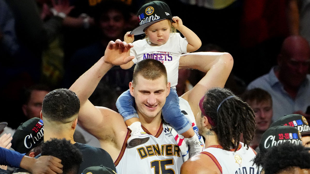 Nuggets center Nikola Jokic (15) celebrates with his daughter