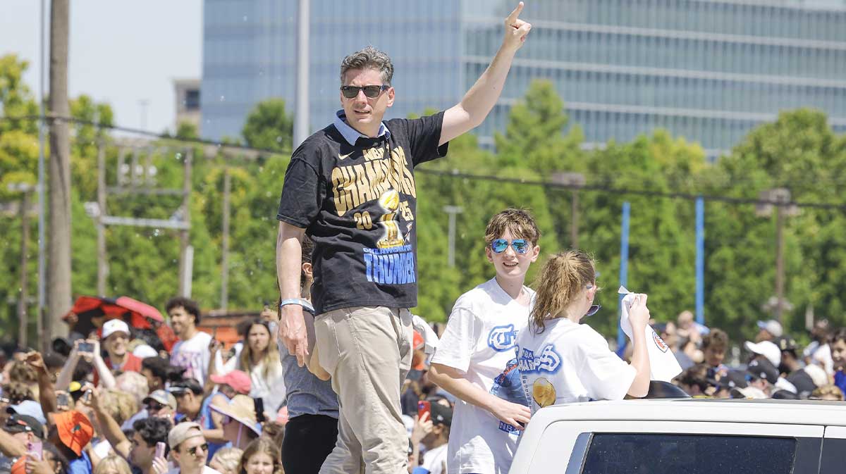 Oklahoma City mayor David Holt waves to fans along the Oklahoma City Thunder Champions parade route Mayor David Holt Thunder in the background