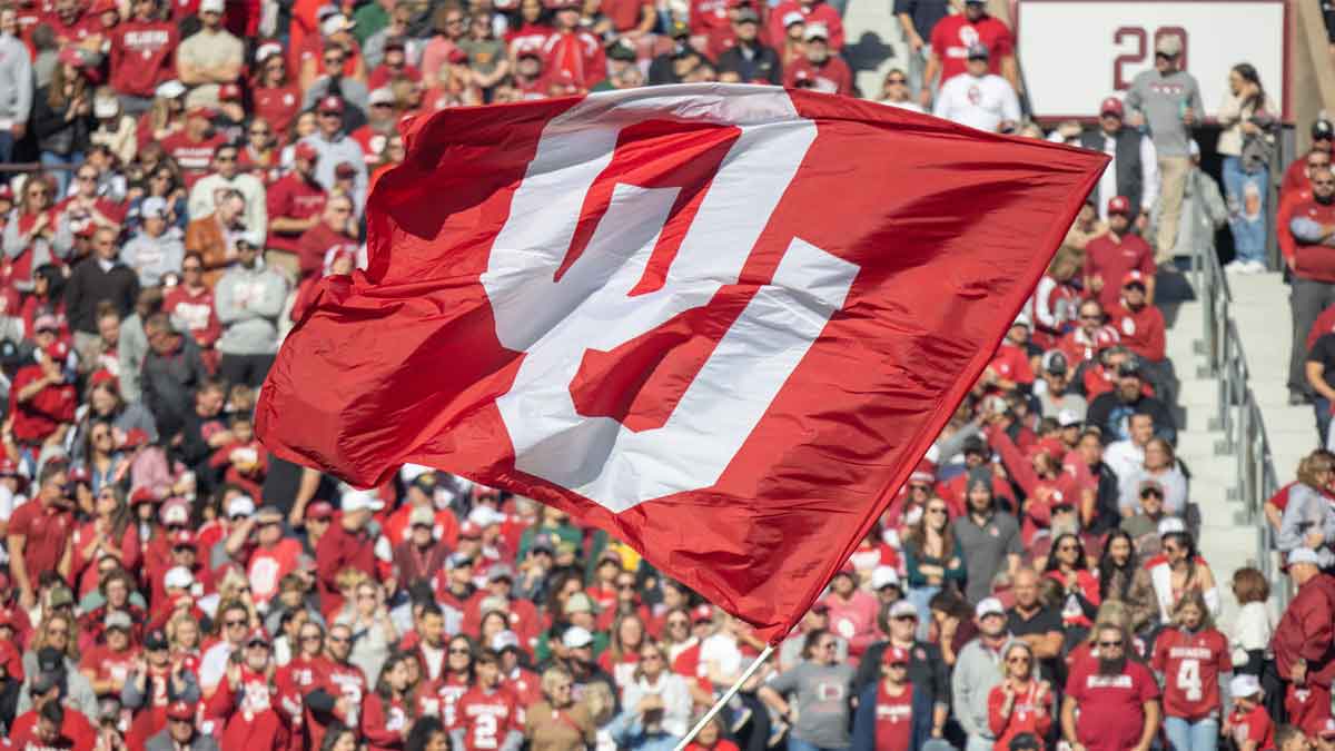 An OU flag is flown during a college football game between the University of Oklahoma Sooners (OU) and the Baylor Bears at Gaylord Family - Oklahoma Memorial Stadium