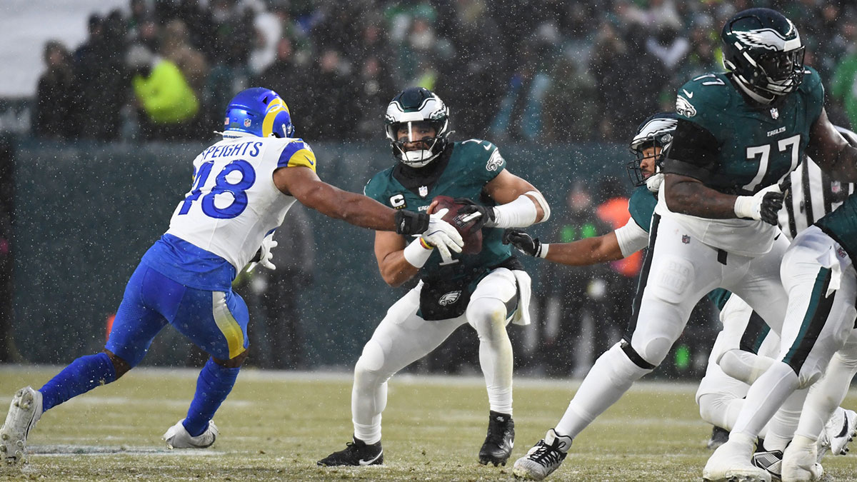 Philadelphia Eagles quarterback Jalen Hurts (1) prepares to throw the ball as Los Angeles Rams linebacker Omar Speights (48) defends in the first half in a 2025 NFC divisional round game at Lincoln Financial Field.