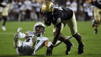 Colorado Buffaloes wide receiver Omarion Miller (4) stays on his feet to score after a tackle attempt from Baylor Bears safety Corey Gordon Jr. (24) during the first half at Folsom Field.