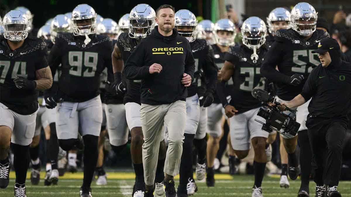 Oregon Ducks head coach Dan Lanning runs out with the team before a game against the Washington Huskies at Autzen Stadium.