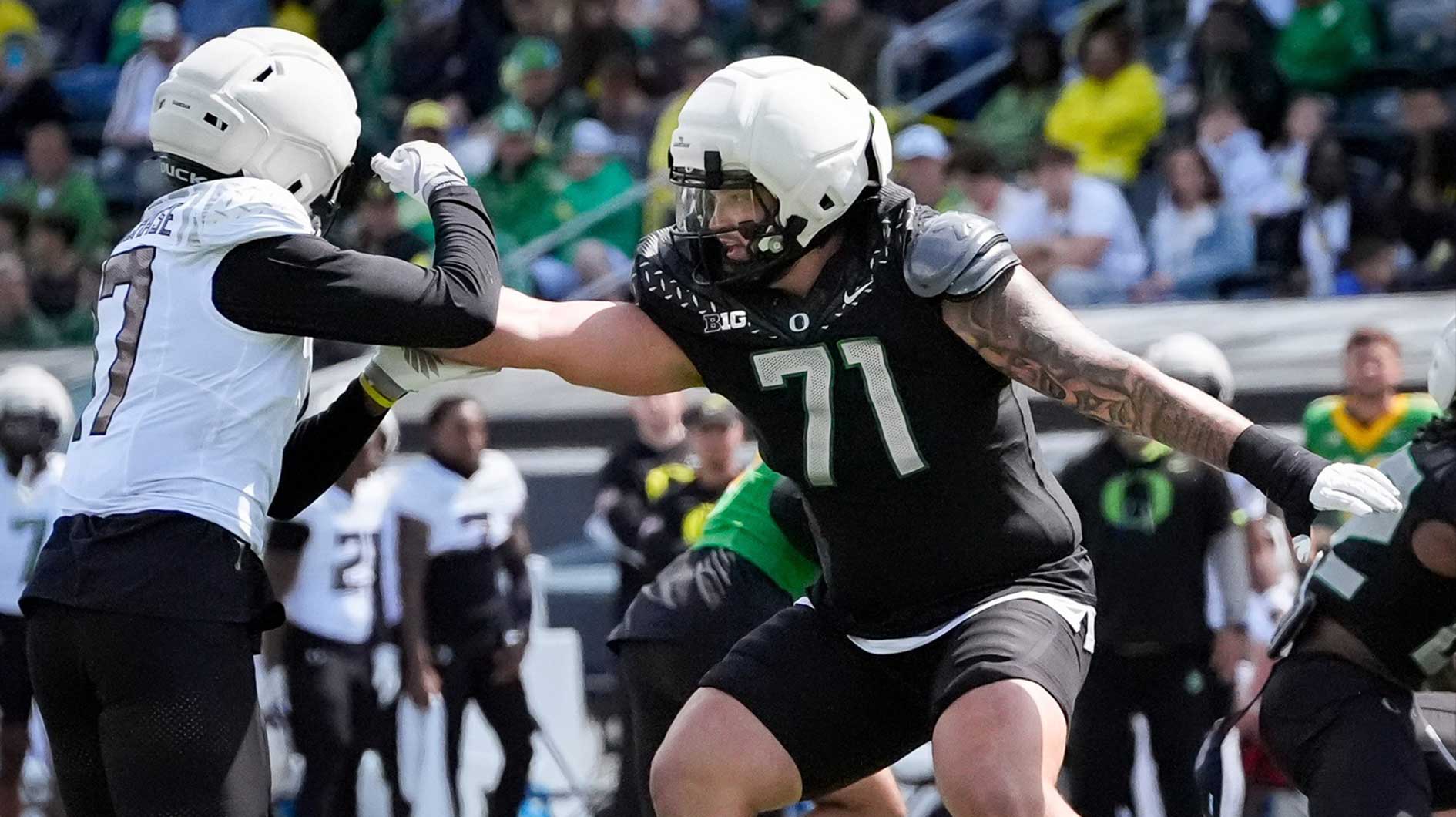 Oregon offensive lineman Alex Harkey, right, guards against outside linebacker Blake Purchase during Oregon football’s spring game April 26, 2025, at Autzen Stadium in Eugene.