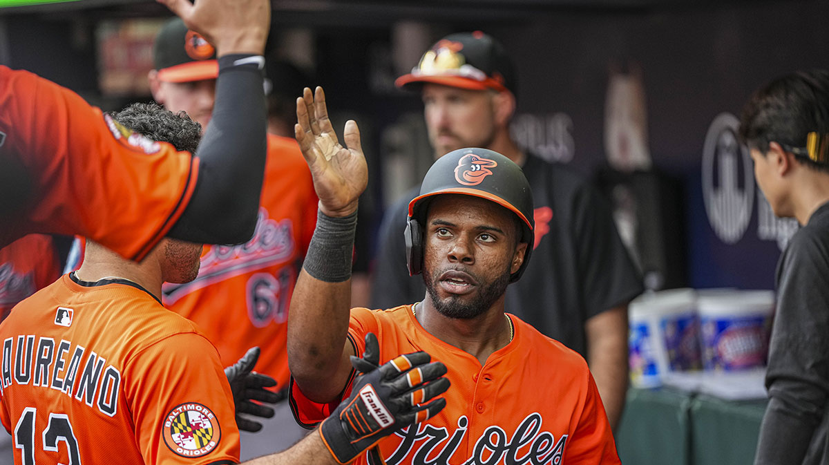 Baltimore Orioles center fielder Cedric Mullins (31) gets handshakes in the dugout after scoring a run against the Atlanta Braves during the seventh inning at Truist Park.