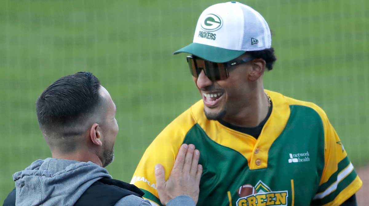 Packers head coach Matt LaFleur shares a laugh with Jordan Love during the Green Bay Charity Softball Game