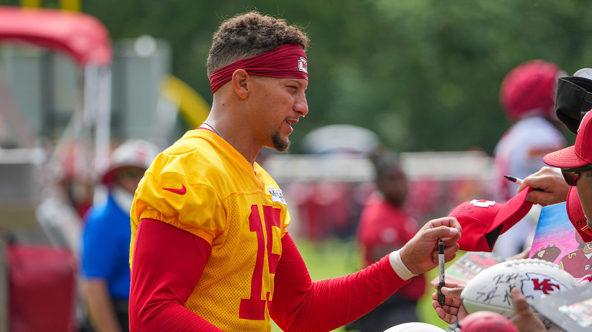 Kansas City Chiefs quarterback Patrick Mahomes (15) signs autographs for fans after training camp