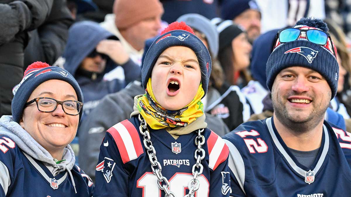 A young New England Patriots fan cheers for the team during the first half against the Indianapolis Colts at Gillette Stadium.