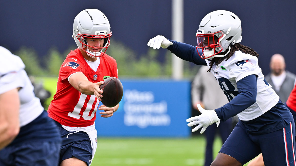 Patriots quarterback Drake Maye (10) hands the ball to running back Rhamondre Stevenson (38) during minicamp at Gillette Stadium
