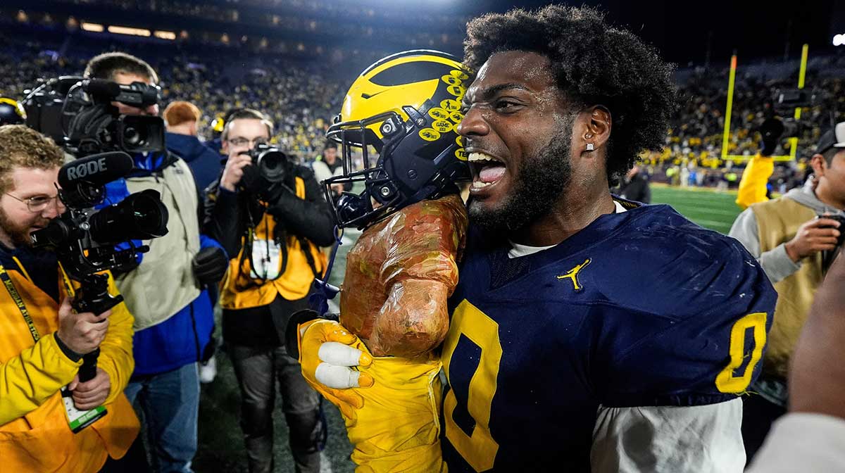 Michigan defensive end Josaiah Stewart (0) celebrates with the Paul Bunyan Trophy after 24-17 win over Michigan State at Michigan Stadium