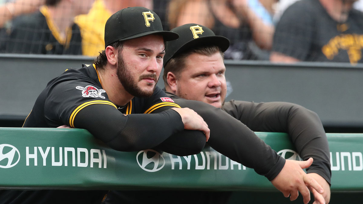 Pittsburgh Pirates starting pitcher Paul Skenes (left) and coach Daniel Vogelbach (right) look on from the dugout against the St. Louis Cardinals during the sixth inning at PNC Park.