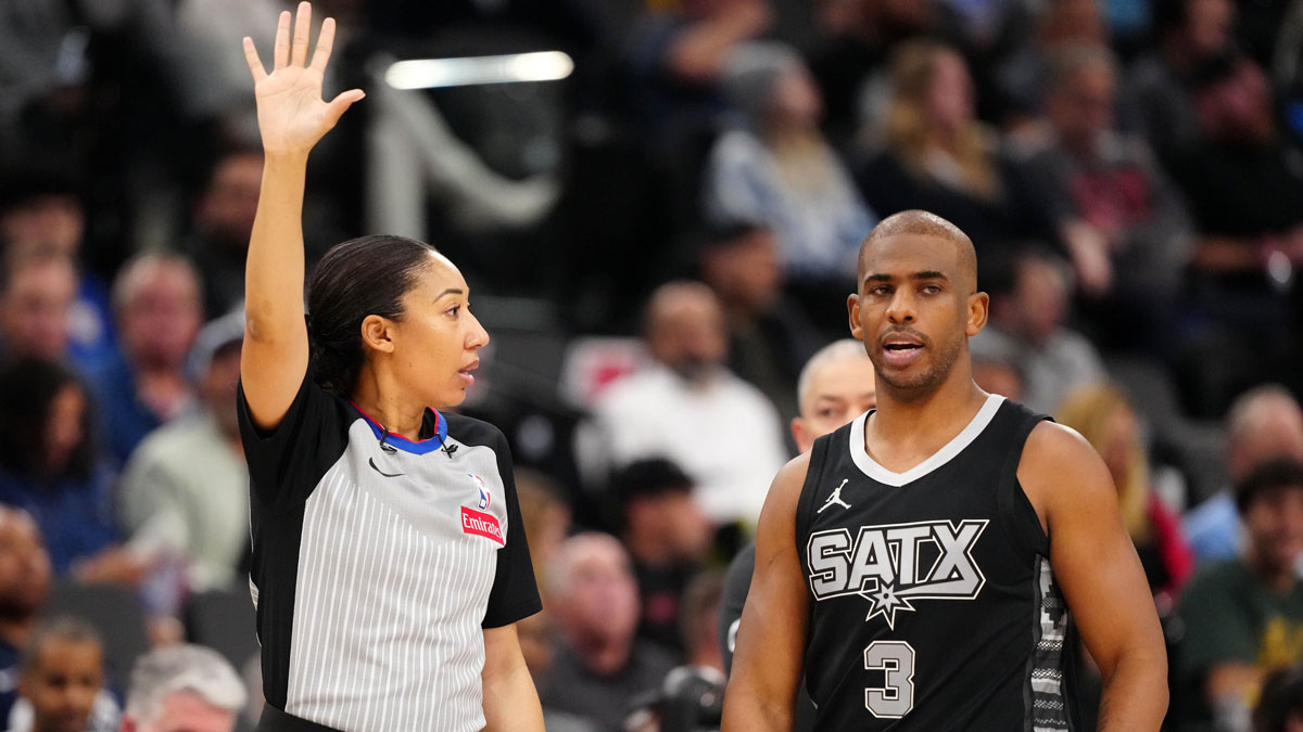 NBA female referee Simone Jelks (left) and San Antonio Spurs guard Chris Paul (3) reacts in the first half of the game between the Spurs and the LA Clippers at Intuit Dome.