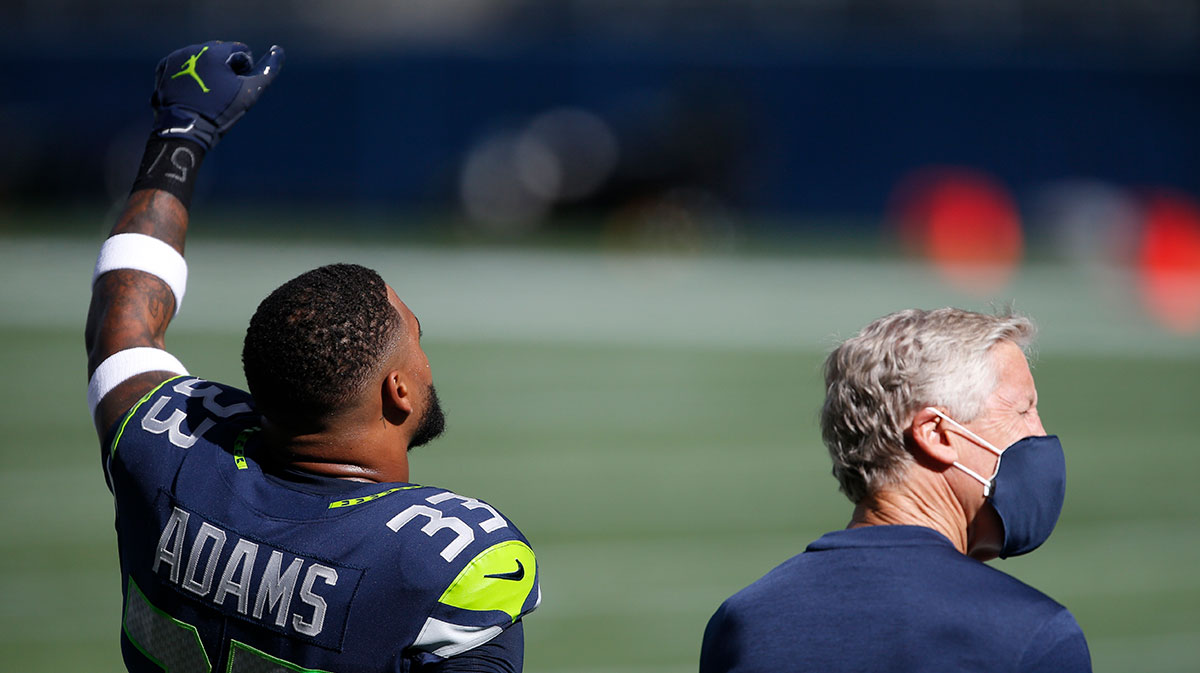 Seattle Seahawks strong safety Jamal Adams (33) and head coach Pete Carroll stand during the national anthem before a game against the Dallas Cowboys at CenturyLink Field.