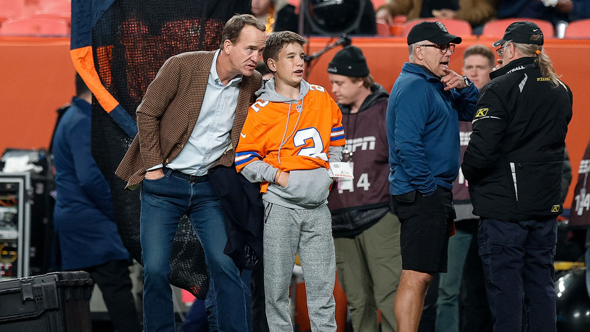 Former Denver Broncos player Peyton Manning with his son Marshall before the game against the Cleveland Browns at Empower Field at Mile High.
