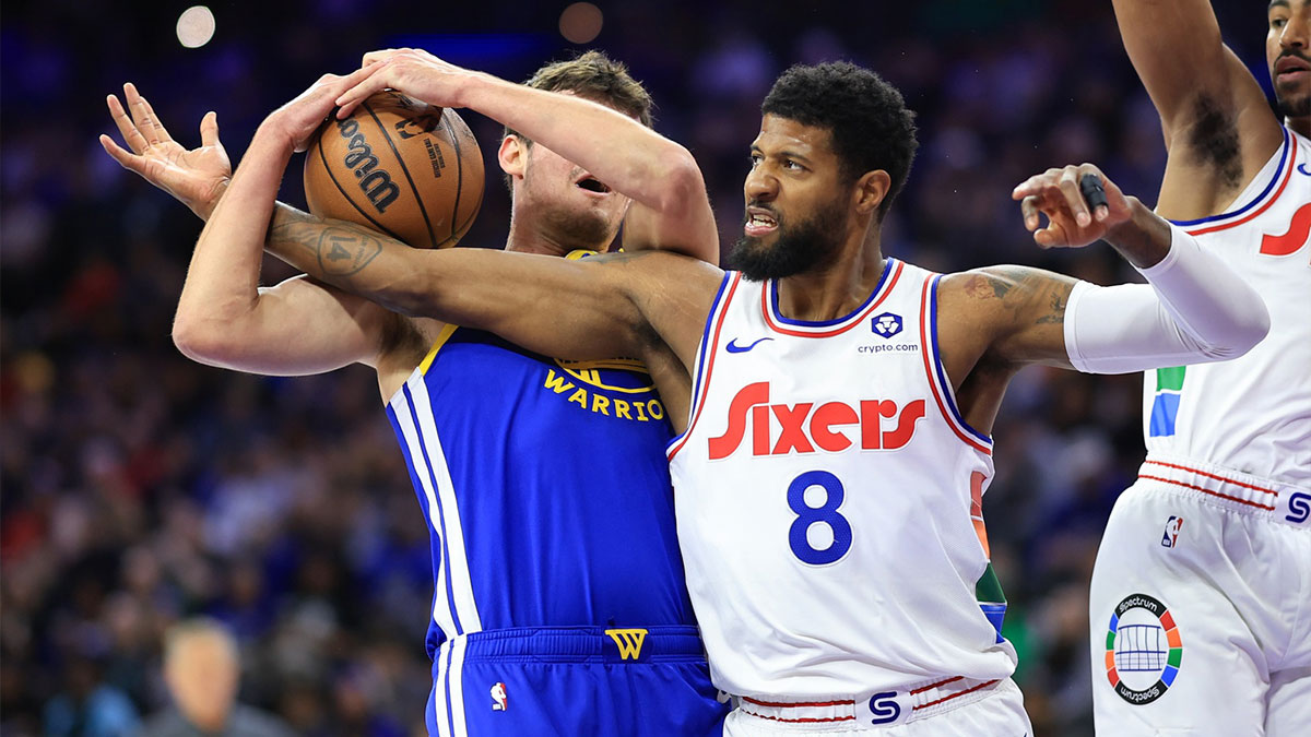 Golden State Warriors center Quinten Post (21) grabs a rebound against Philadelphia 76ers forward Paul George (8) during the first quarter at Wells Fargo Center.