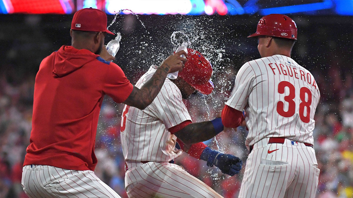 Philadelphia Phillies second base Edmundo Sosa (33) celebrates a walk-off win on catcher's interference with teammates during the tenth inning against the Boston Red Sox at Citizens Bank Park.