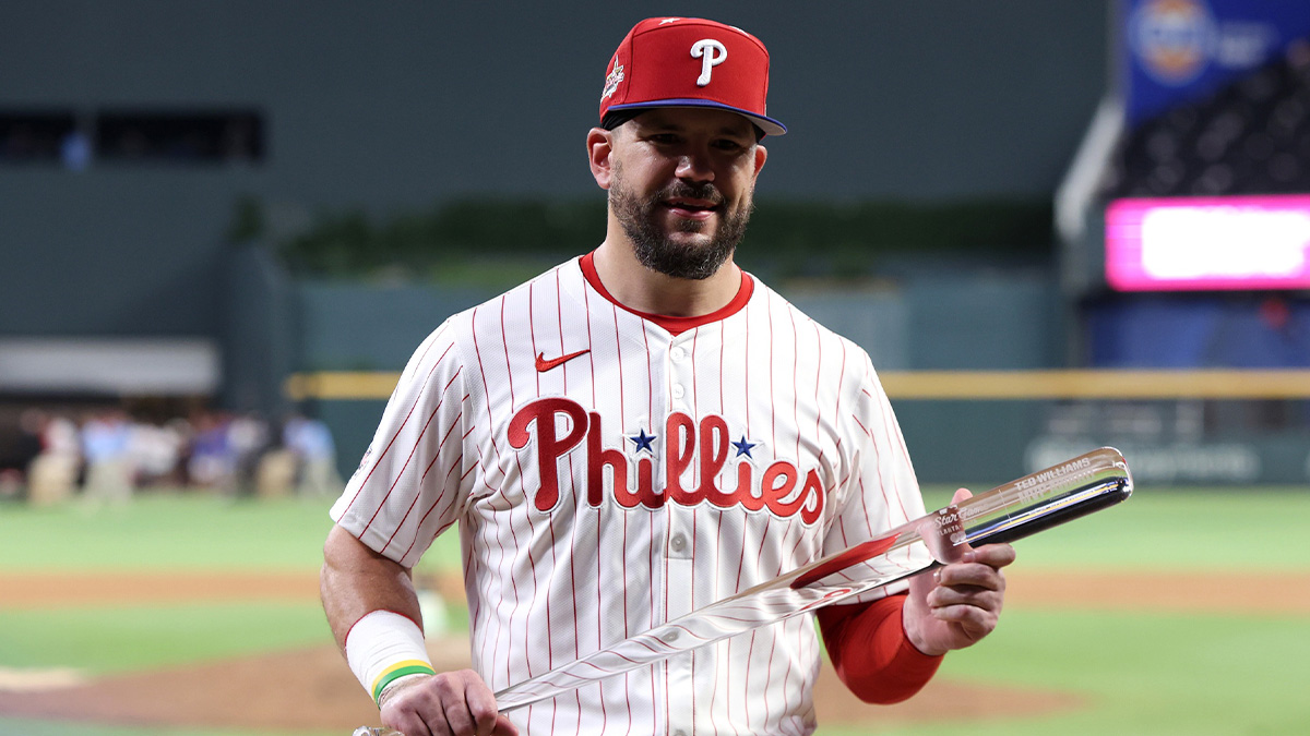 National League designated hitter Kyle Schwarber (12) of the Philadelphia Phillies celebrates with the MVP trophy after defeating the American League in the 2025 MLB All Star Game at Truist Park.