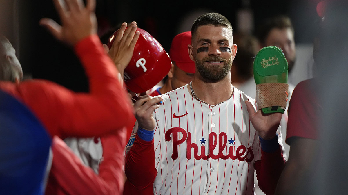 Phillies infielder Bryce Harper (3) celebrates with teammates after scoring a run against the Boston Red Sox in the eleventh inning at Citizens Bank Park