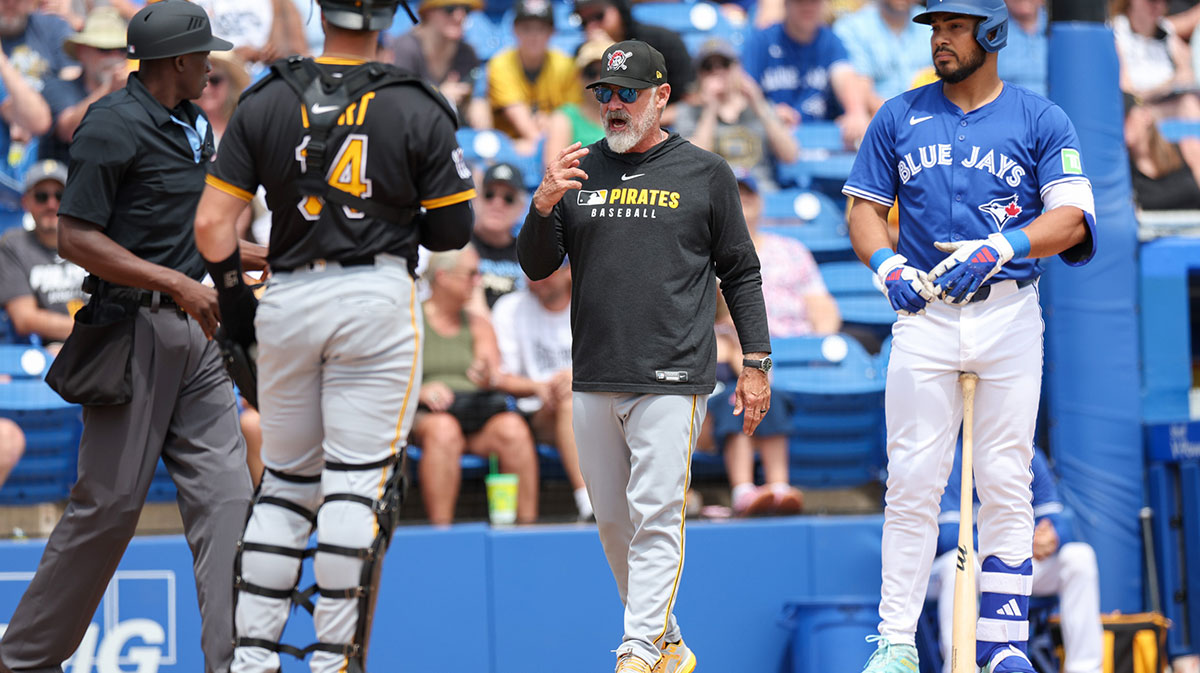 Pittsburgh Pirates manager Derek Shelton (17) speaks to umpire Felix Neon after a play against the Pittsburgh Pirates in the third inning during spring training at TD Ballpark.
