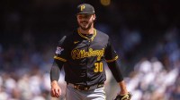 Pittsburgh Pirates starting pitcher Paul Skenes (30) smiles as he walks off the field during the third inning at T-Mobile Park.