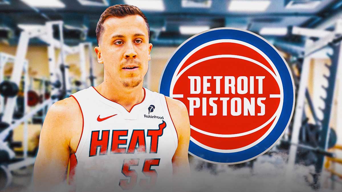 Duncan Robinson in a gym next to a Pistons logo