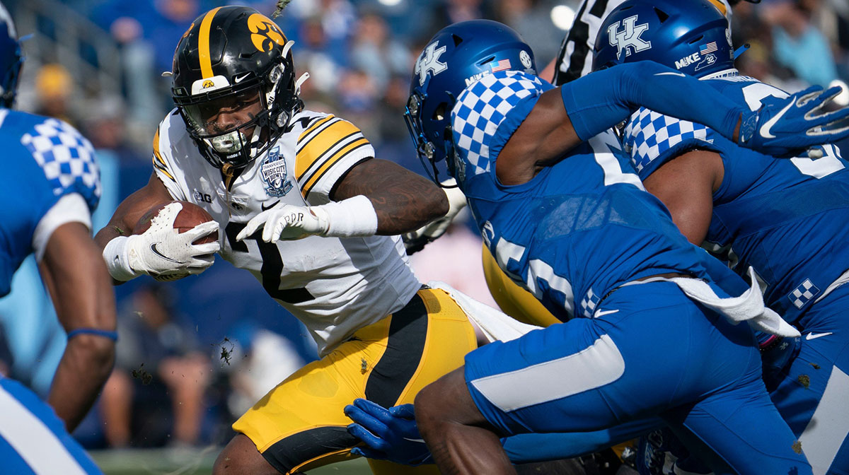 Iowa running back Kaleb Johnson (2) rushes past Kentucky defenders during the first quarter of the TransPerfect Music City Bowl, Saturday, Dec. 31, 2022, at Nissan Stadium in Nashville, Tenn.