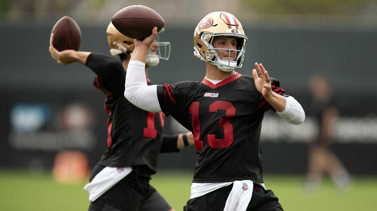 San Francisco 49ers quarterbacks Tanner Mordecai (14) and Brock Purdy (13) throw during a passing drill on the second day of training camp.