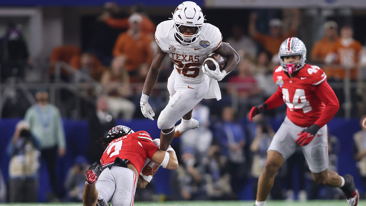 Texas Longhorns running back Quintrevion Wisner (26) is tackled by Ohio State Buckeyes cornerback Jordan Hancock (7) during the third quarter of the College Football Playoff semifinal in the Cotton Bowl at AT&T Stadium.