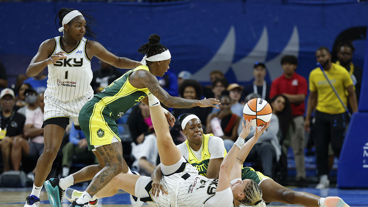 Chicago Sky guard Rachel Banham (24) tries to pass the ball against Seattle Storm center Dominique Malonga (14) and guard Erica Wheeler (17) during the first half at Wintrust Arena.