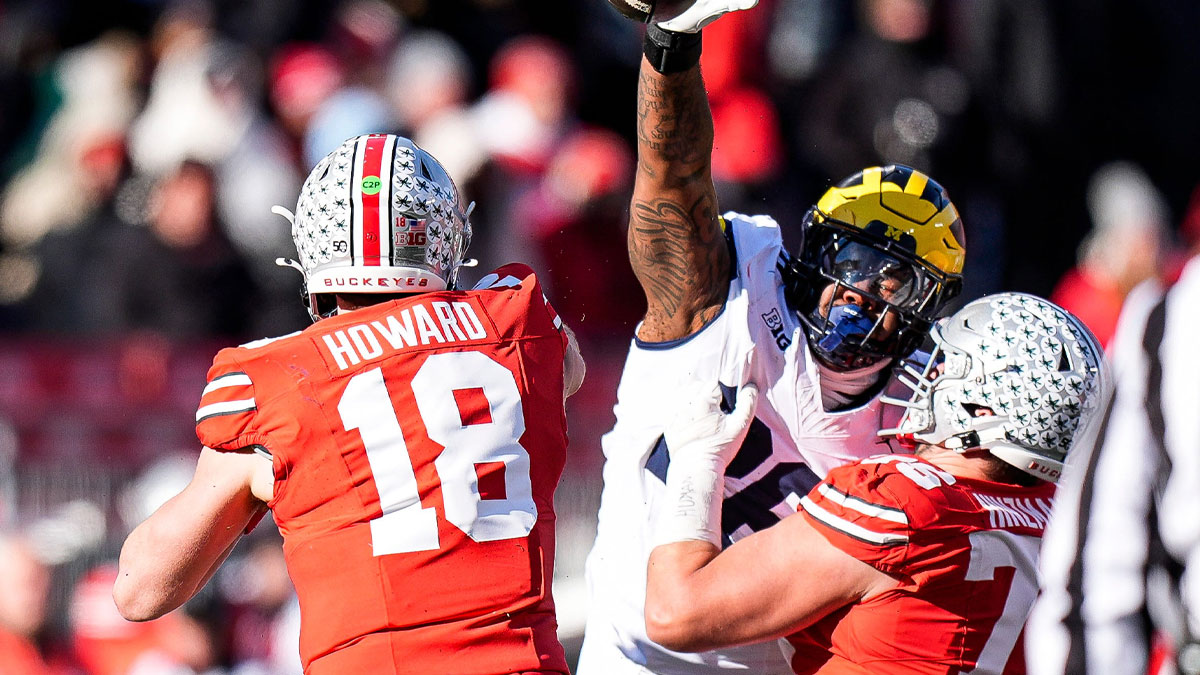 Michigan defensive lineman Rayshaun Benny (26) tries to block a pass from Ohio State quarterback Will Howard (18) during the second half at Ohio Stadium
