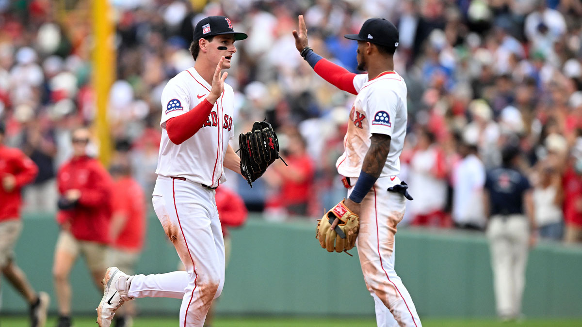 Boston Red Sox right fielder Roman Anthony (19) high-fives center fielder Ceddanne Rafaela (3) after a game against the Los Angeles Dodgers at Fenway Park.