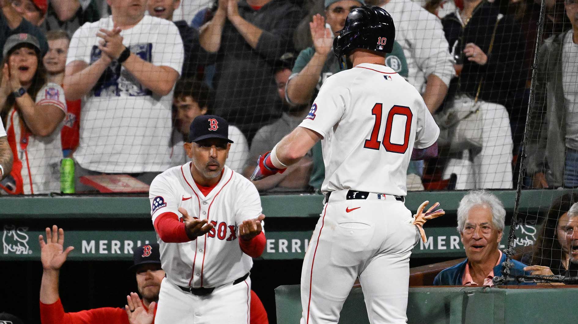Red Sox shortstop Trevor Story (10) is greeted by manager Alex Cora